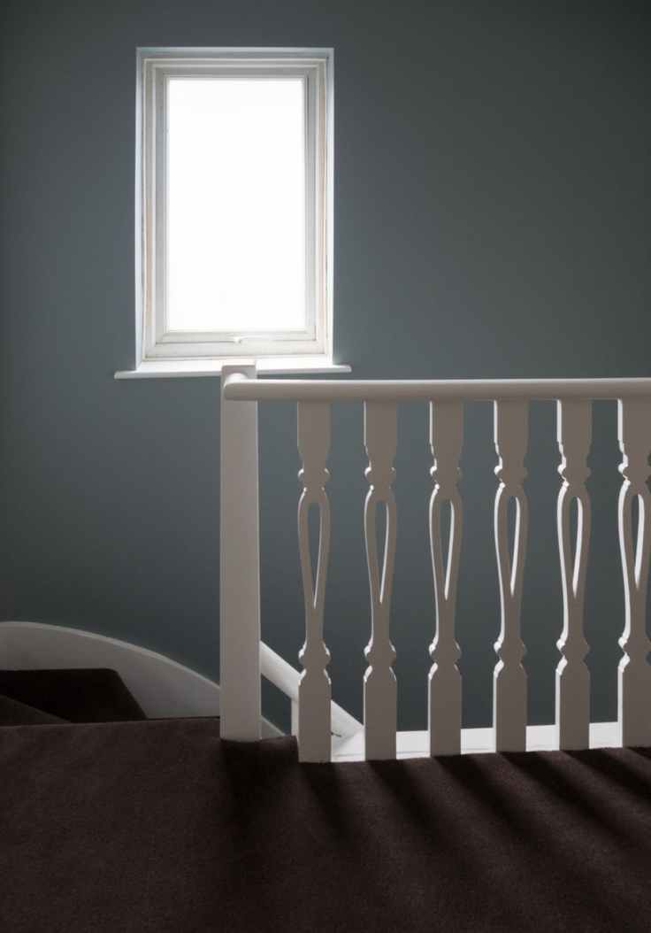photo of white window frame an white wooden stair balustrade